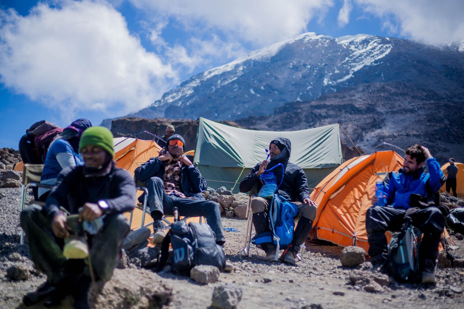 Essential Kilimanjaro hiking gear including boots, jackets, and backpack