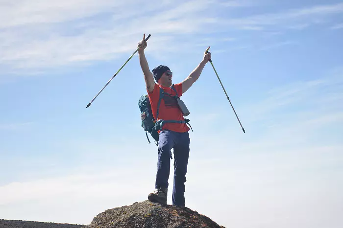 Climbers walking slowly on Kilimanjaro trail with guides leading the way
